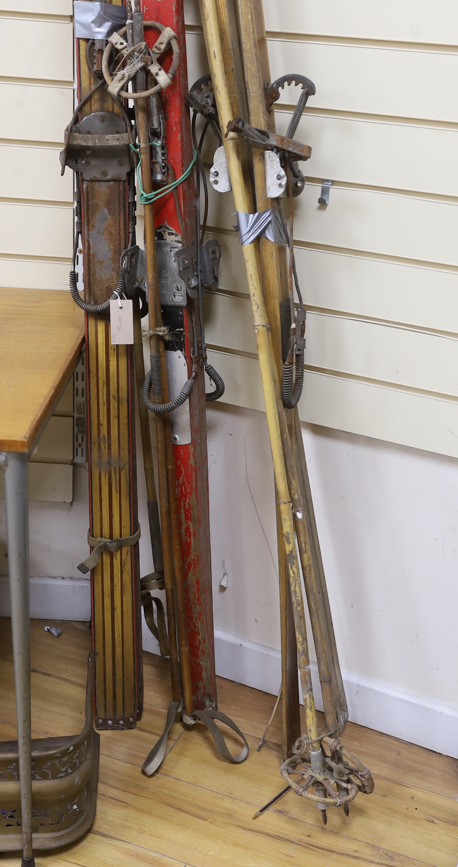 Three pairs of 1950's wooden skis, each with a pair of bamboo poles by Hickory-Sole, Derby, Sport-Fenn, Hereford and Schafer, longest 211cm